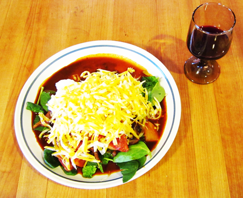 Plate filled with lettuce, taco meat sauce, fermented salsa, kefir cream cheese and chedder