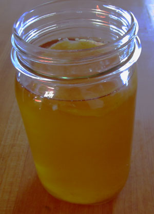 Mason jar of kombucha with a scoby on top