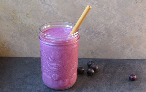 Mason jar filled with blueberry smoothie