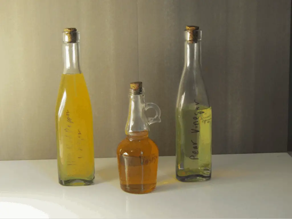 three bottles of different types of homemade vinegar