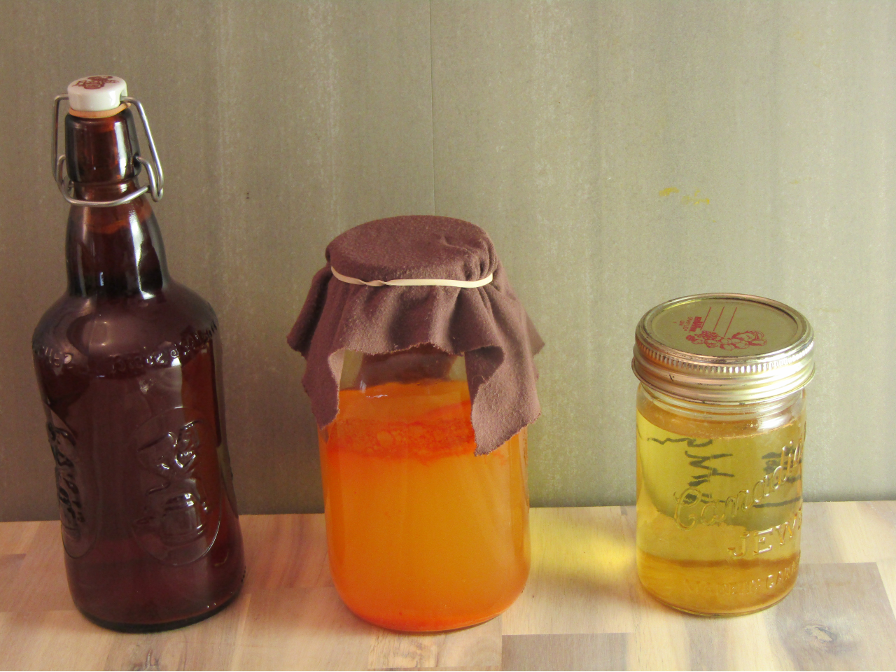 three containers of vinegar