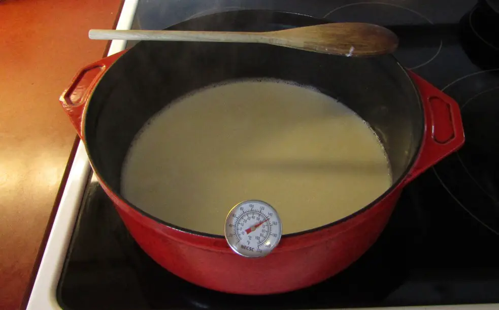 Pot with thermometer and hot milk