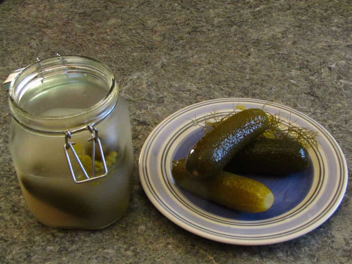Jar of pickles with some on a plate