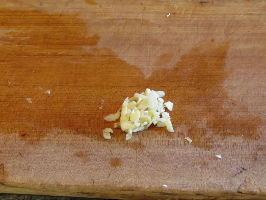 Minced garlic on a cutting board