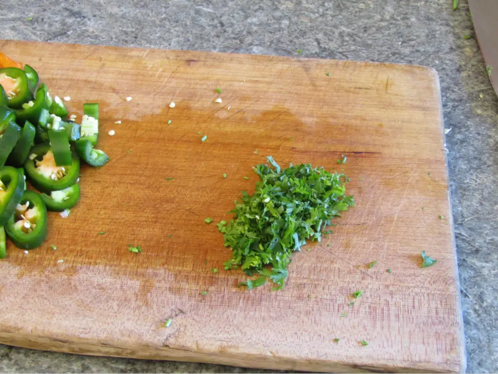 Closeup of minced parsly on a cutting board