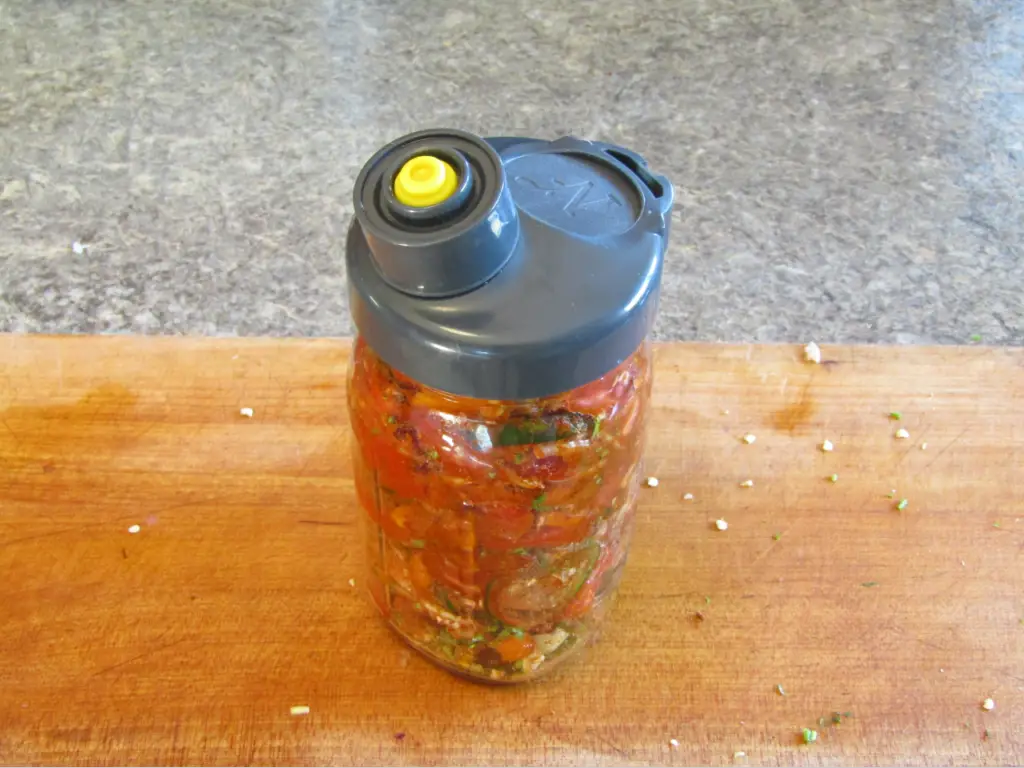 Salsa packed into a mason jar with an airlocked lid
