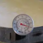 A pot of cream with a thermometer reading 180 degrees fahrenheit