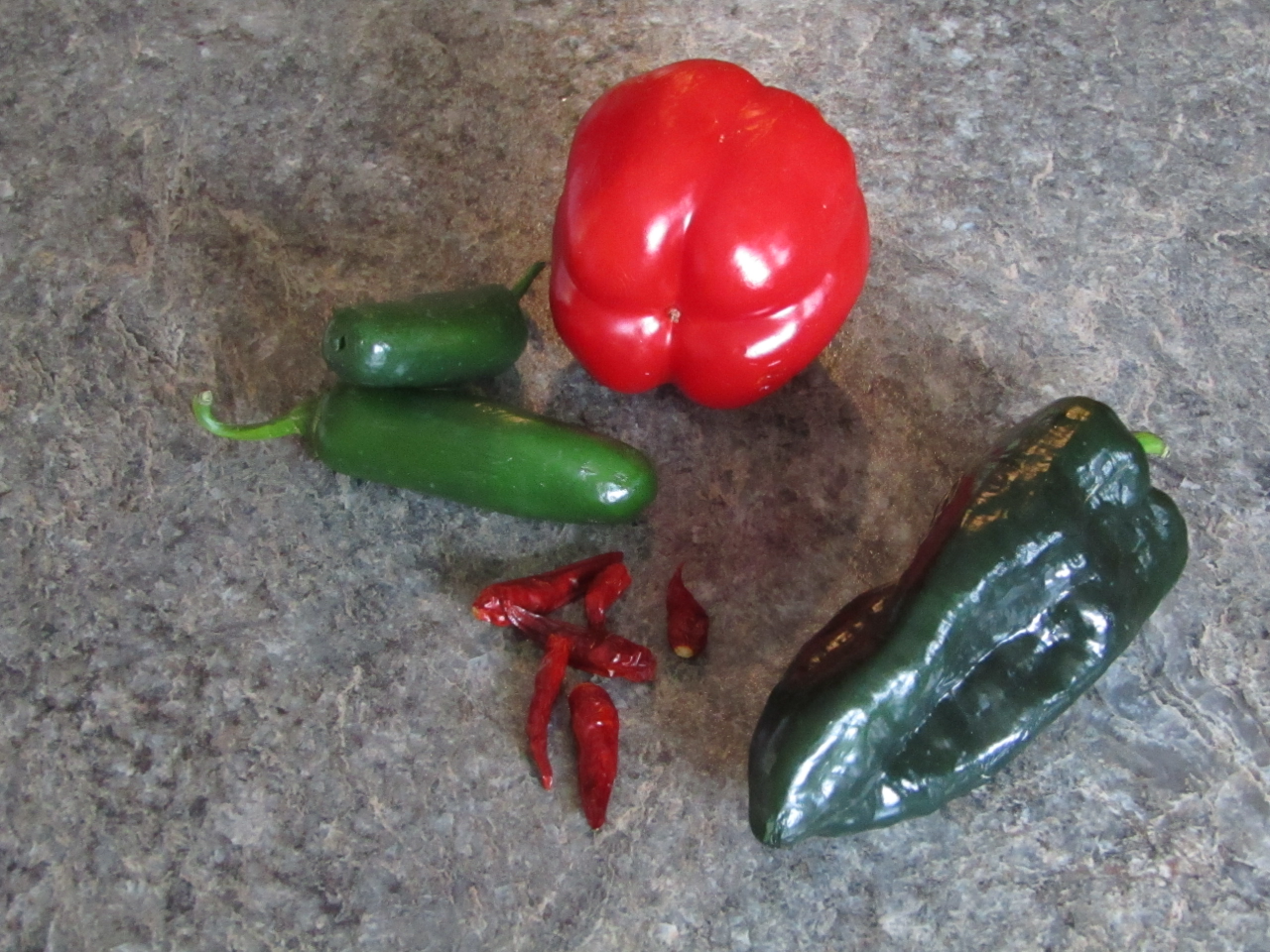 four different pepper types jalapeno, hot red, red bell and poblano