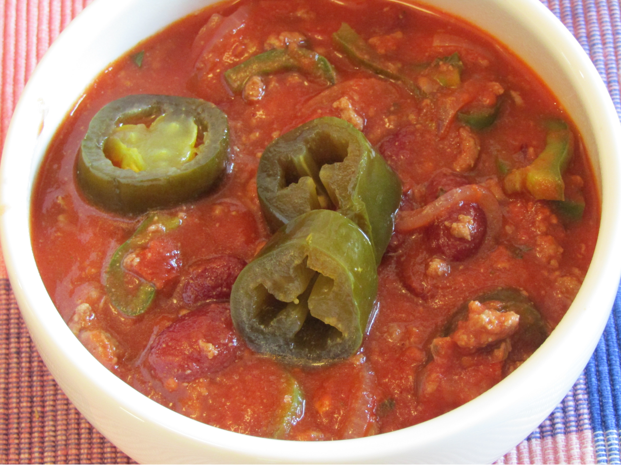 Bowl of chili toped with fermented jalapenos