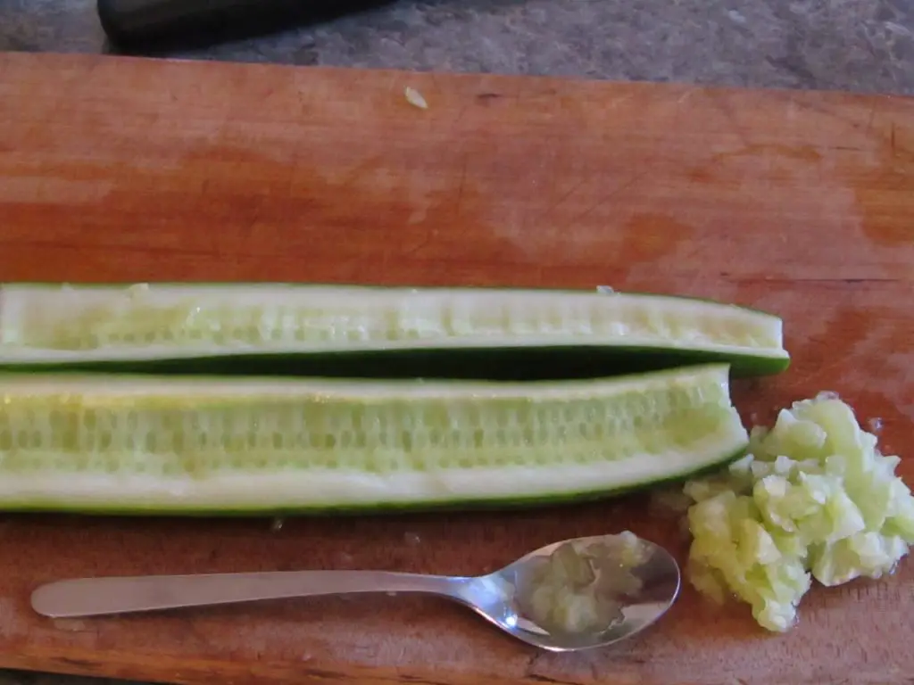 Deseeded cucumber with a spoon 