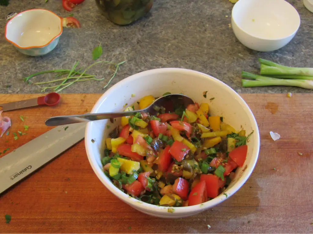 Bowl filled with fresh salsa ingredients all mixed together