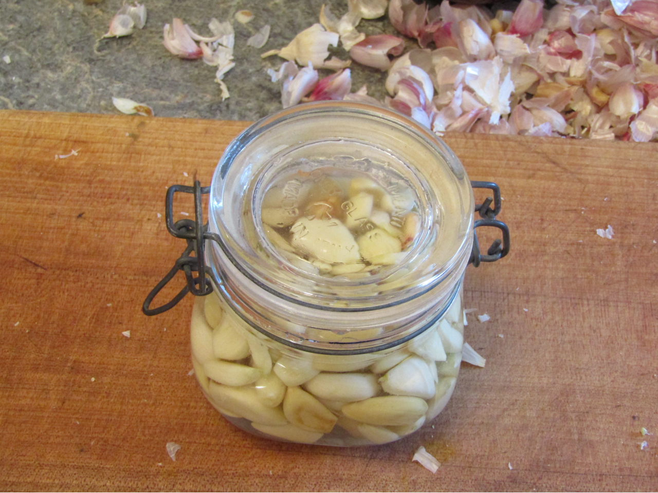 sealed jar filled with garlic cloves salt and water