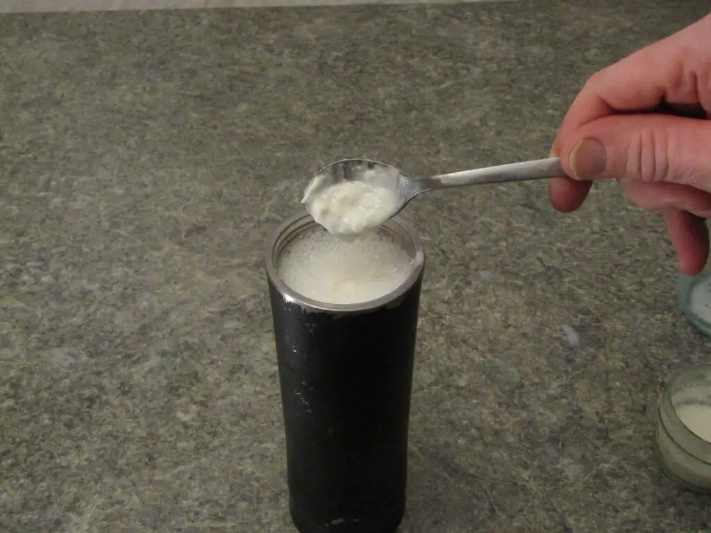 Adding yogurt culture to powdered milk in a thermos