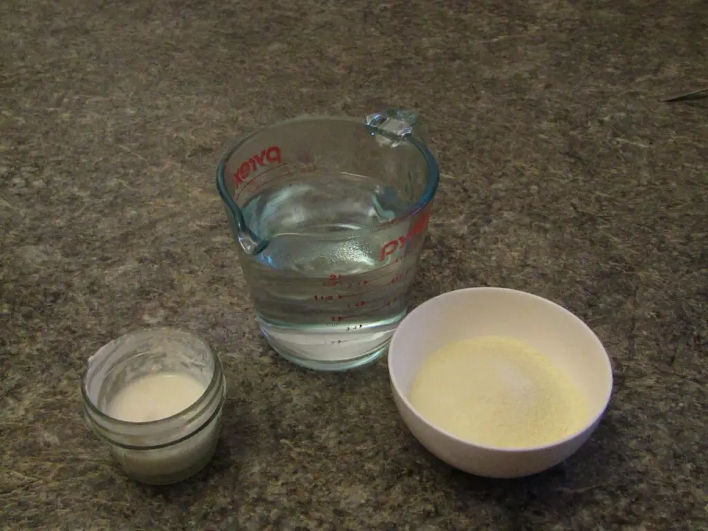 Ingredients for making powdered milk yogurt. Hot water, yogurt culture and powdered milk