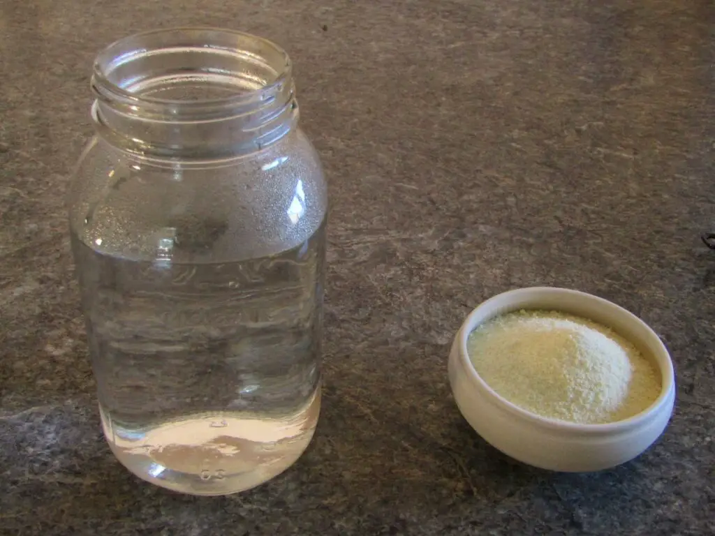 hot water in a mason jar and powdered milk in a bowl