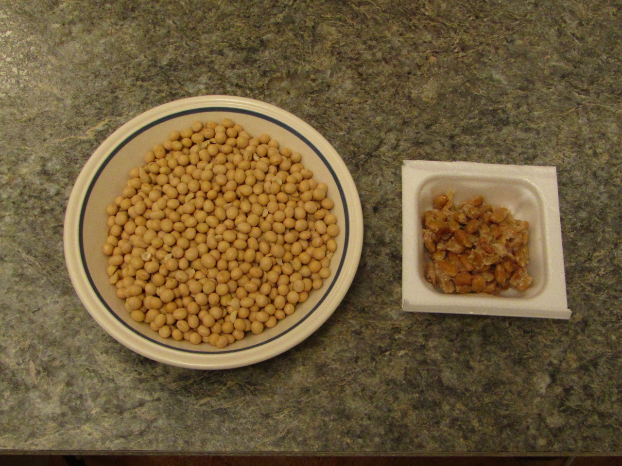 bowl of dried soy beans and a container of fermented natto
